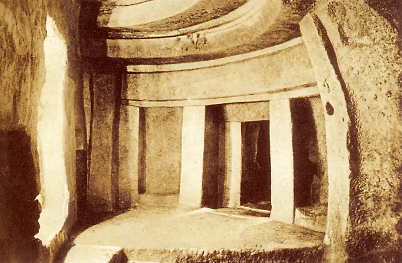 An underground chamber at the Ħal Saflieni Hypogeum carved into rock, imitating post-and-lintel and arch forms