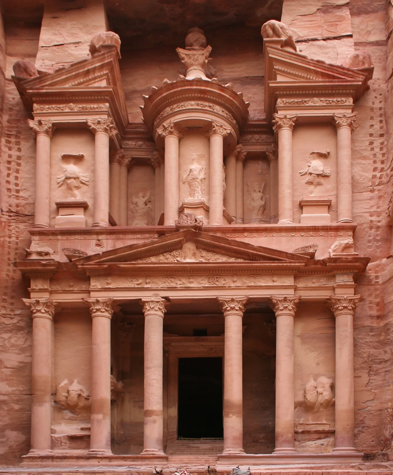 The Corinthian-columned facade of Al-Khazneh carved into the sandstone cliff at Petra