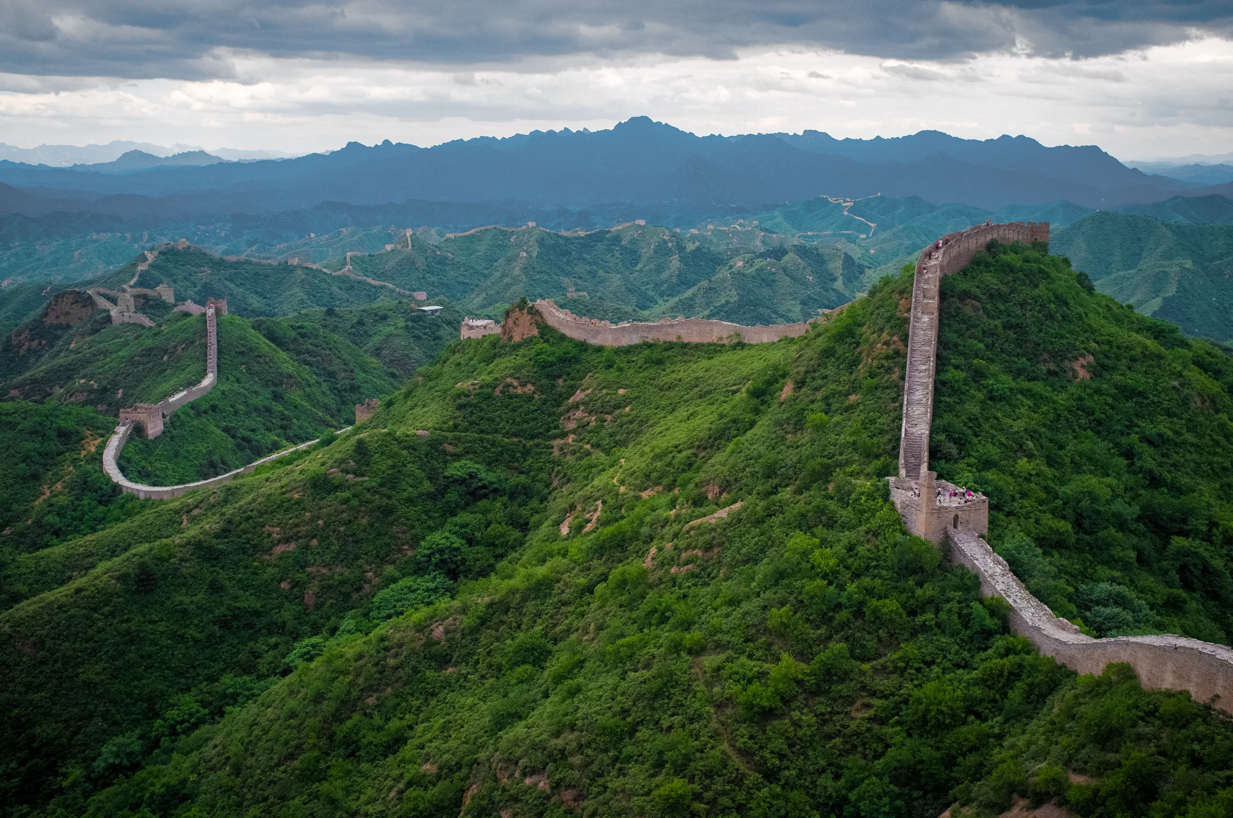 A stone- and brick-faced section of the Great Wall running along the mountain ridges at Jinshanling
