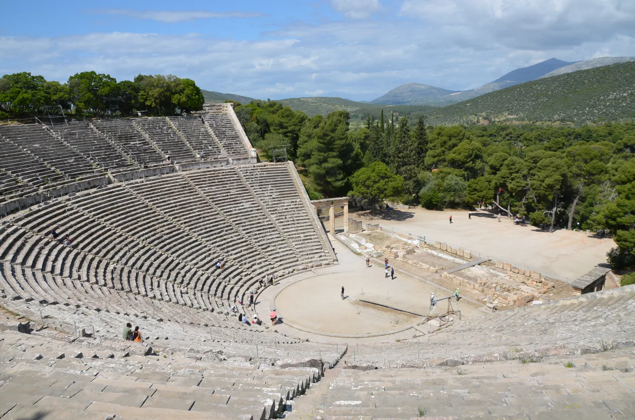The stone seating tiers at Epidaurus, more than a semicircle, set into a natural slope around the central circular orchestra