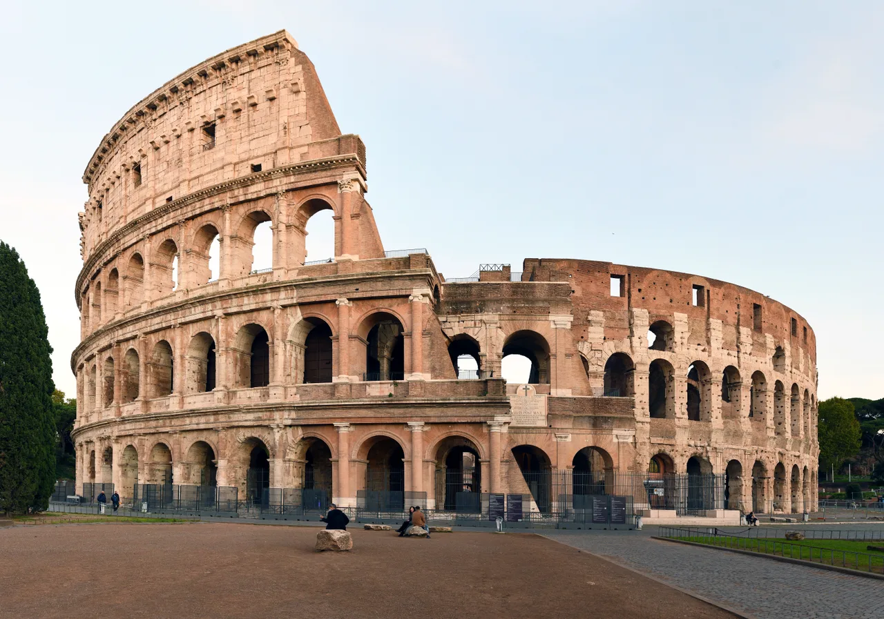 The multi-tiered arched exterior of the Colosseum with superimposed orders of columns