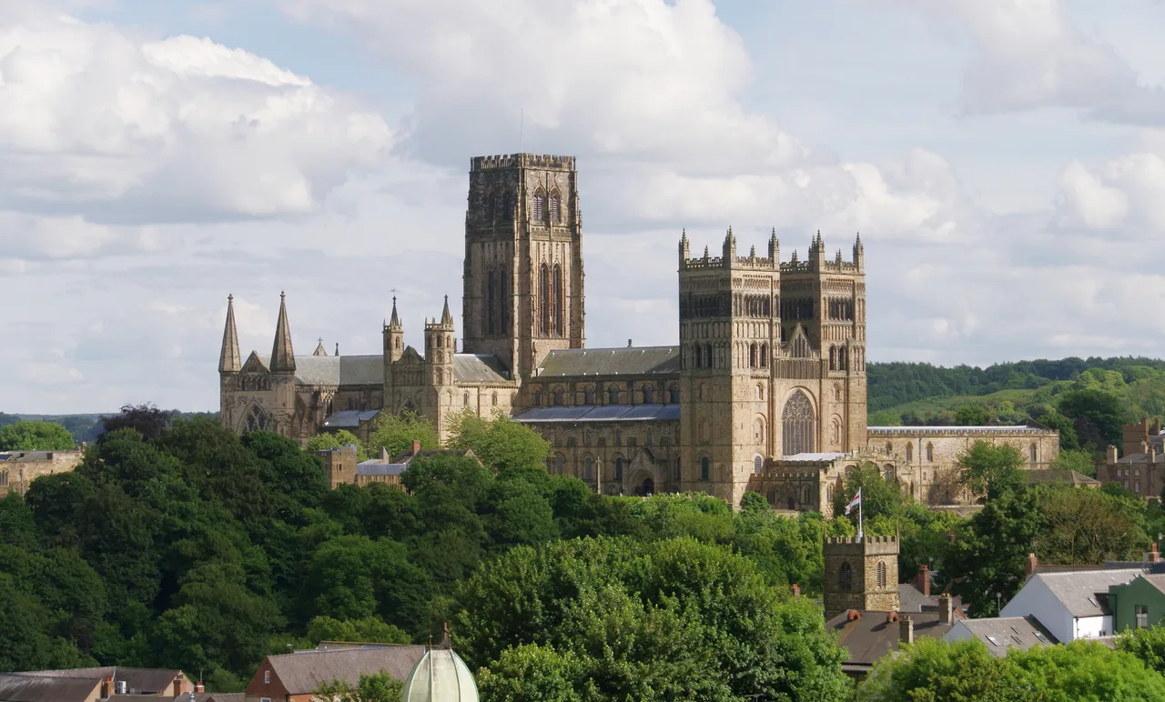The mass of Durham Cathedral above the river; two western towers and a central tower over the heavy Romanesque body