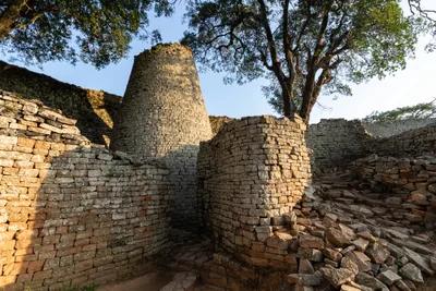 The solid conical stone tower in the Great Enclosure of Great Zimbabwe and the curving mortarless granite wall around it