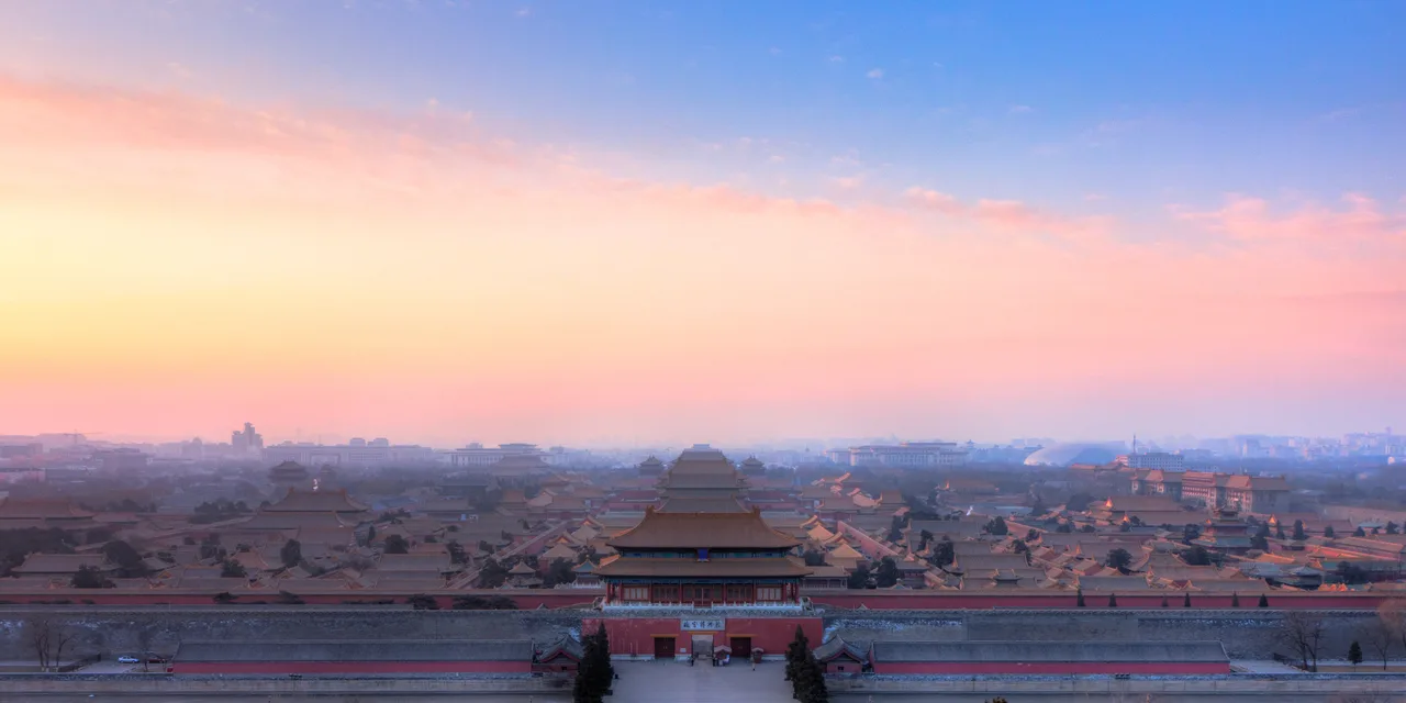 The axially arranged courtyards and broad-eaved roofs of the Forbidden City seen from Coal Hill