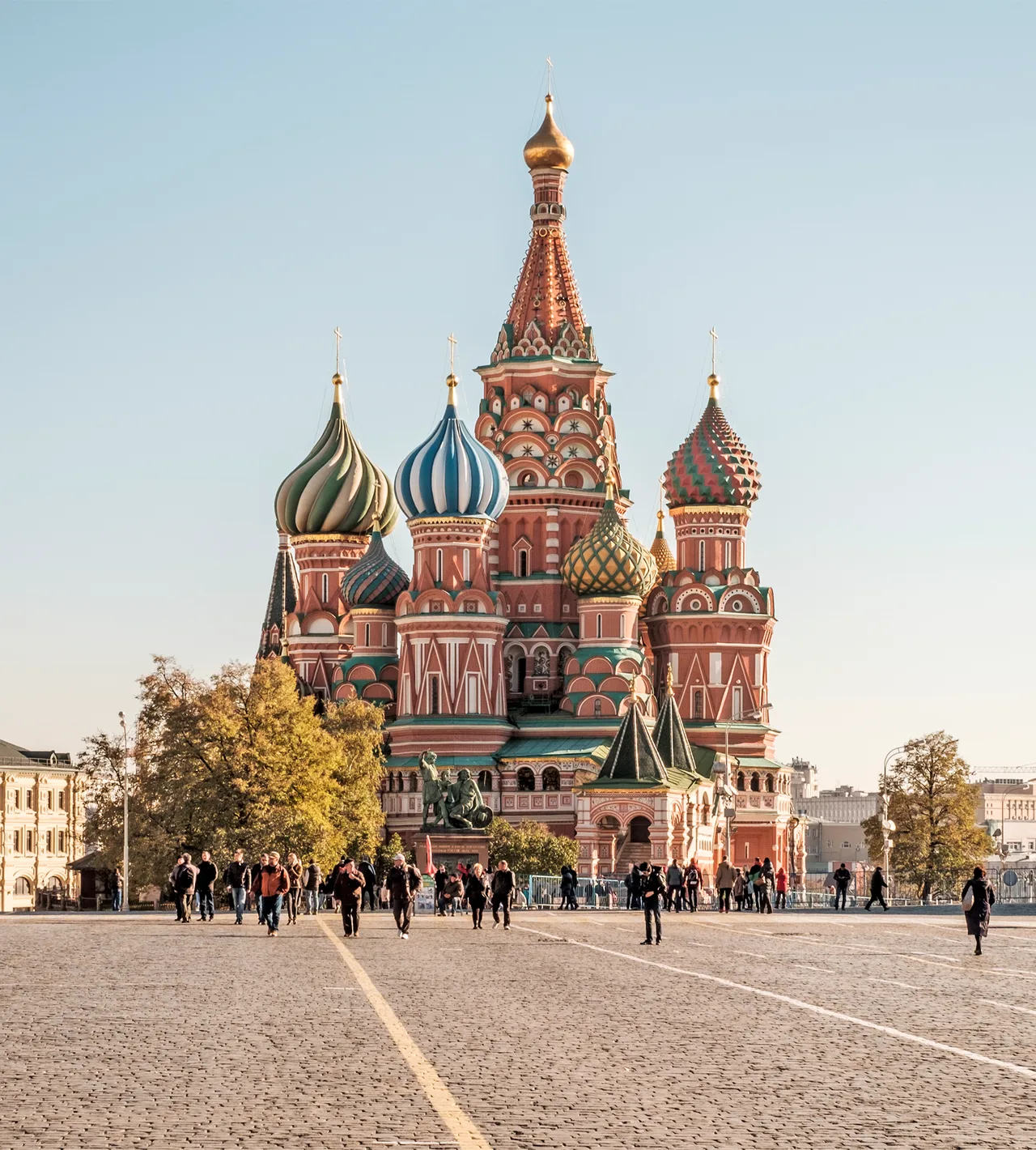 The chapels of Saint Basil's Cathedral clustered on one base, with onion domes of different colours and forms