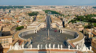The elliptical double colonnade embracing St Peter's Square with the central obelisk; the basilica's dome behind