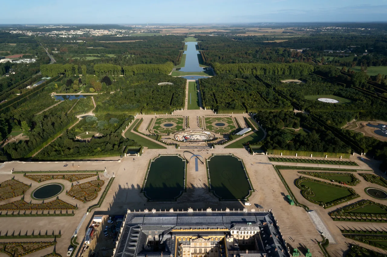 Aerial view of the Palace of Versailles and its gardens along the perspective axis