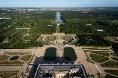 Aerial view of the Palace of Versailles and its gardens along the perspective axis