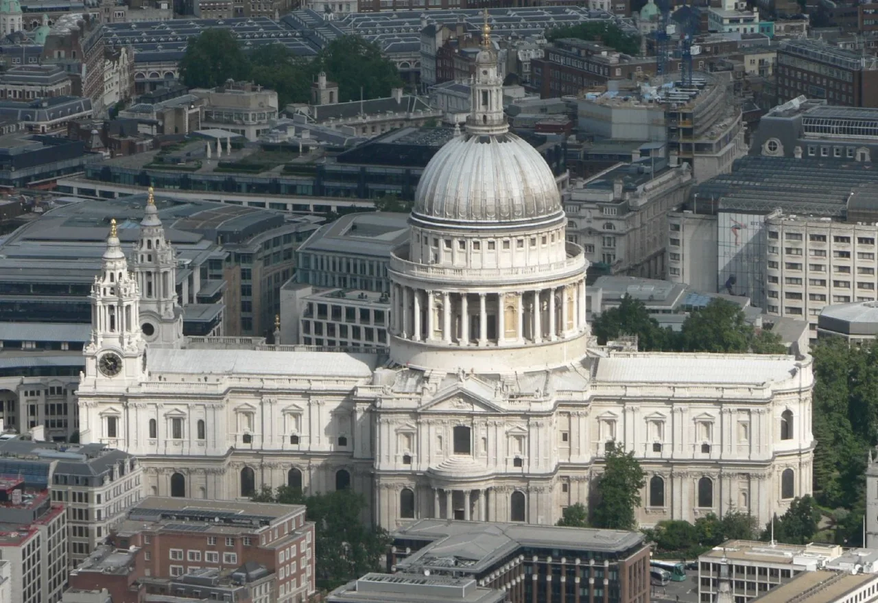 An aerial view of St Paul's Cathedral; its tall lead-clad outer dome and stone lantern dominating the London skyline