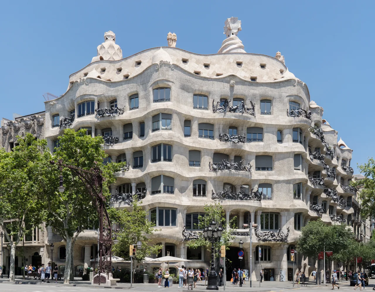 The undulating, continuously curving cut-stone façade and wrought-iron balconies of Casa Milà