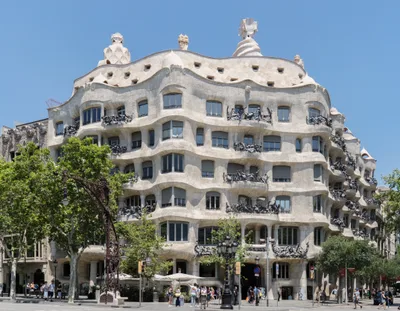 The undulating, continuously curving cut-stone façade and wrought-iron balconies of Casa Milà