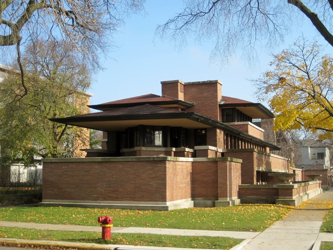 The long horizontal brick masses of Robie House and its columnless cantilevered eaves reaching metres outward