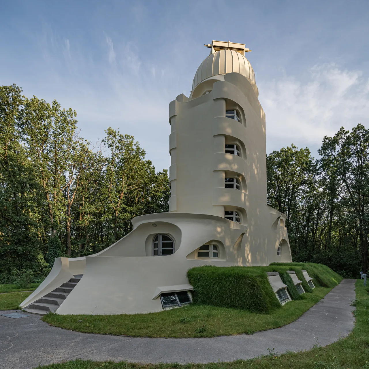 The fluid, rendered mass of the Einstein Tower; windows turning around corners and an organically budding entrance