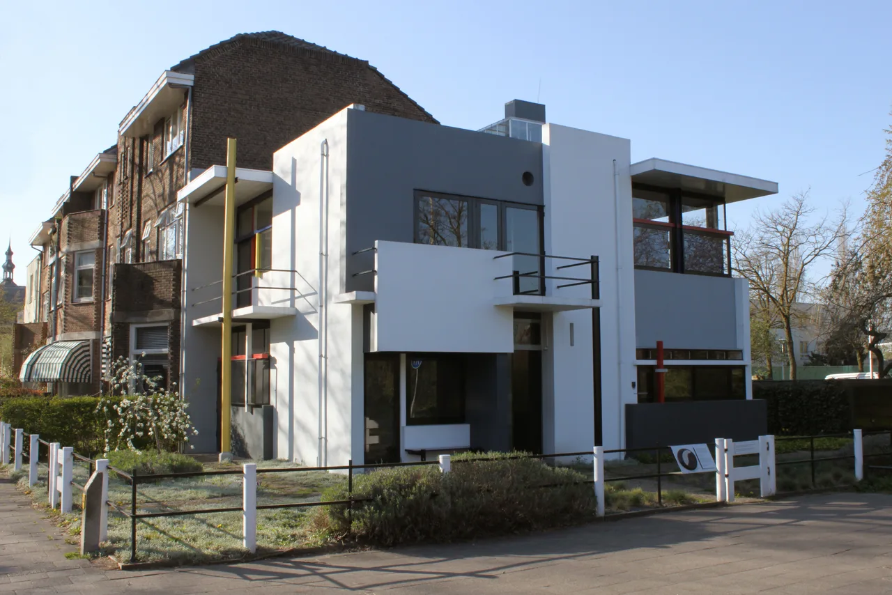 The façade of the Schröder House composed of sliding white-grey planes and red-yellow-blue linear elements