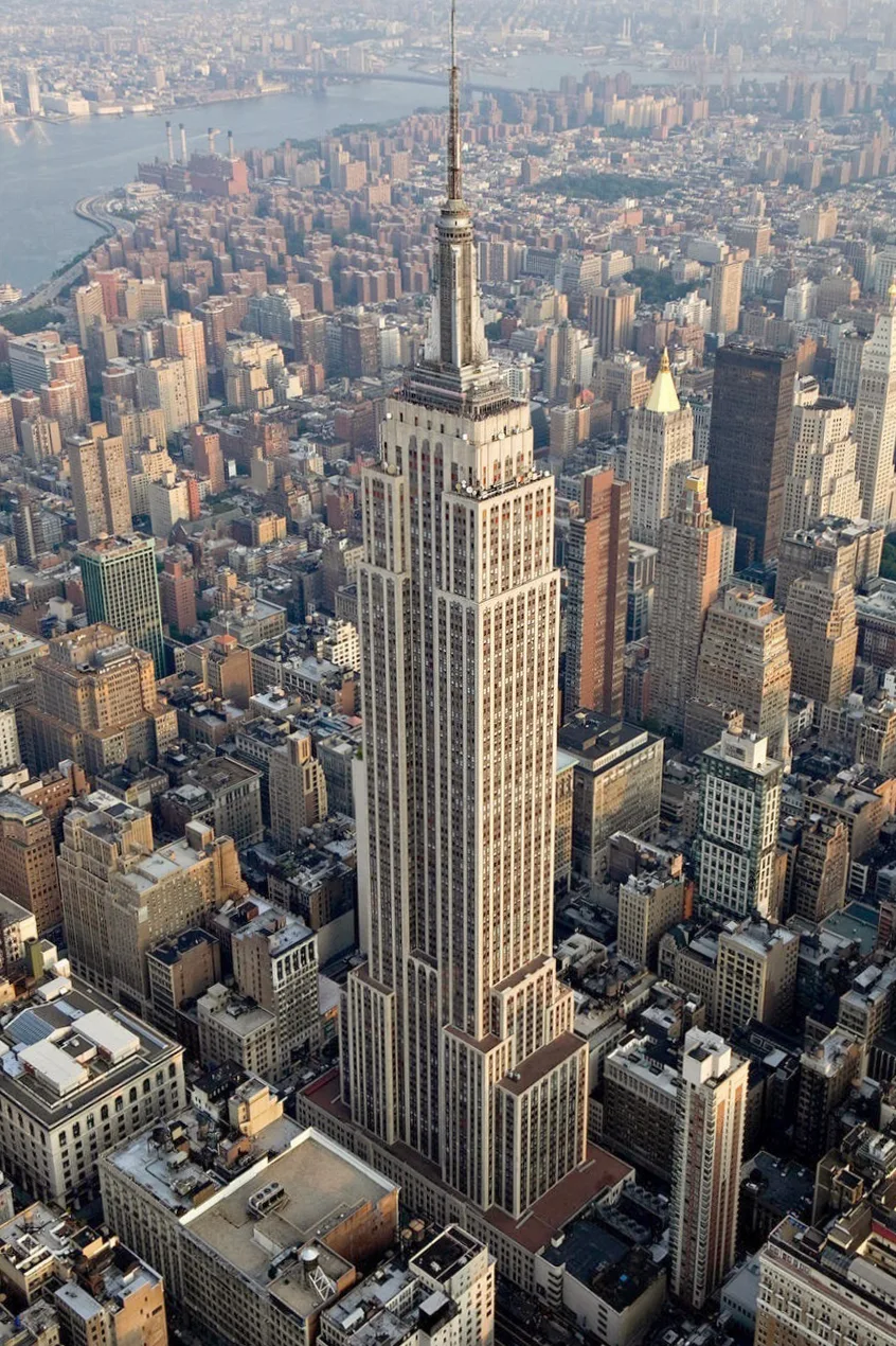 The stepped Art Deco mass of the Empire State Building seen from the air