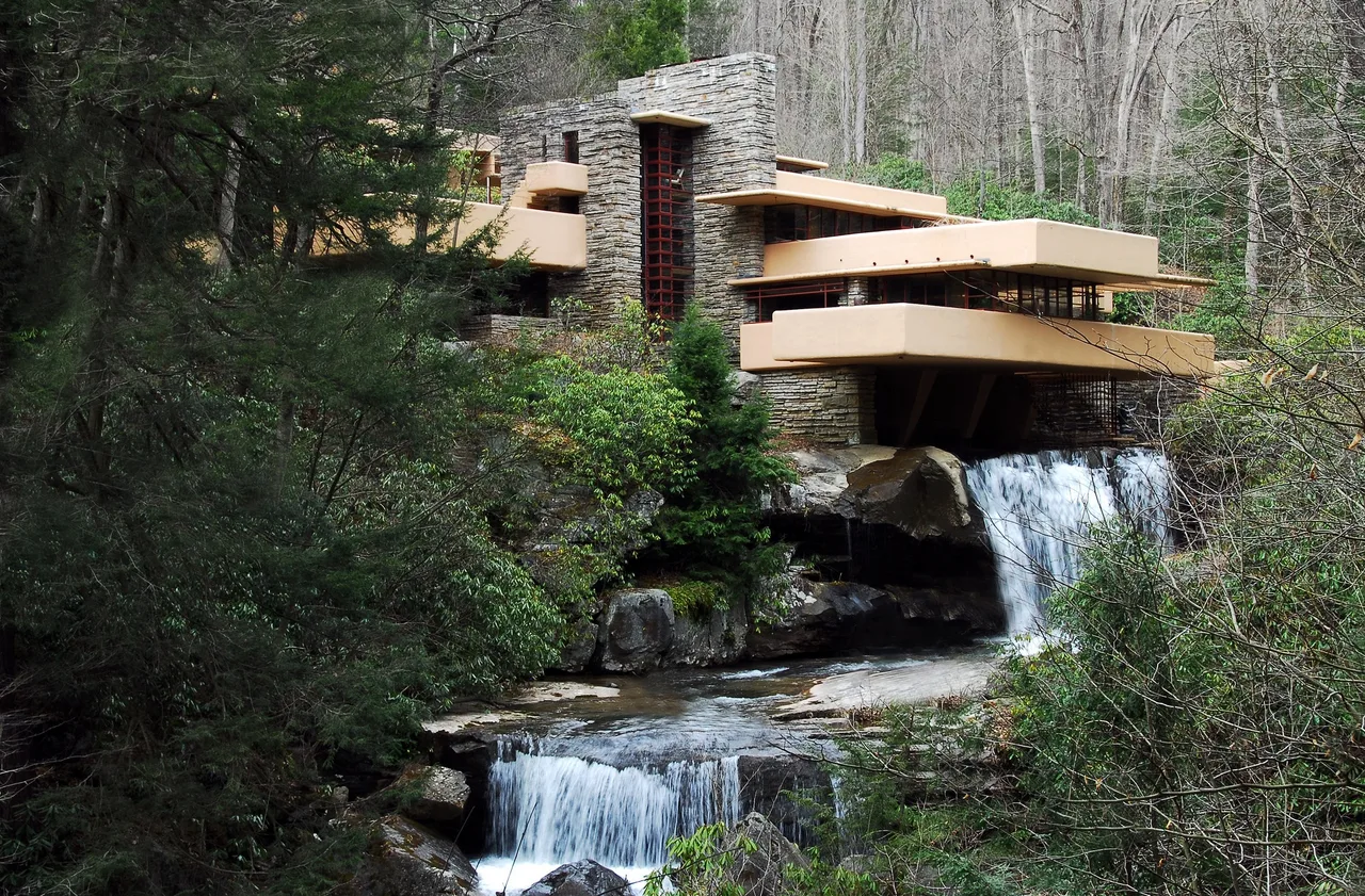 The cantilevered concrete terraces of Fallingwater reaching out over a waterfall