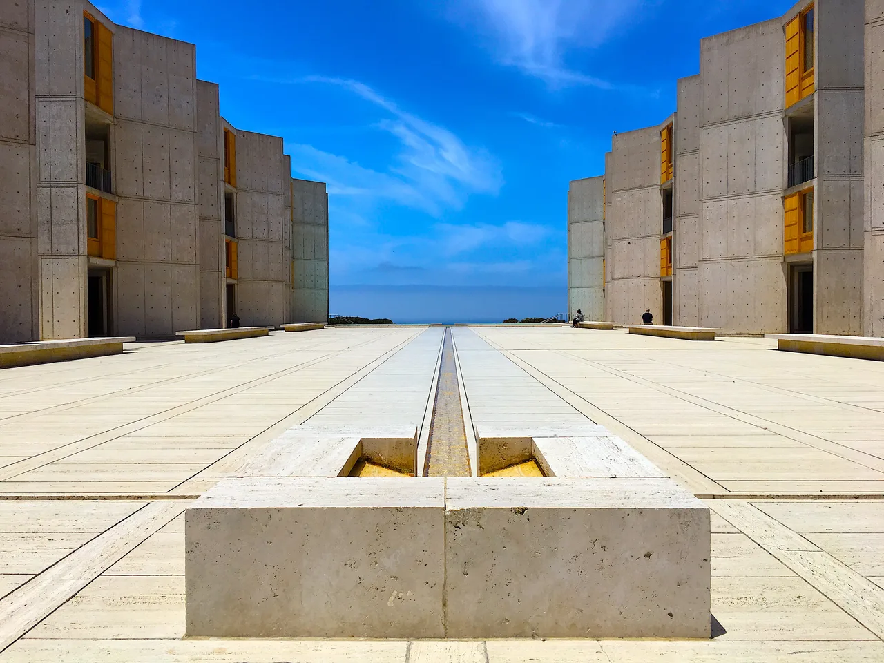 The symmetrical concrete laboratory blocks of the Salk Institute and the empty courtyard, opening to the horizon, with a thin water channel down its middle