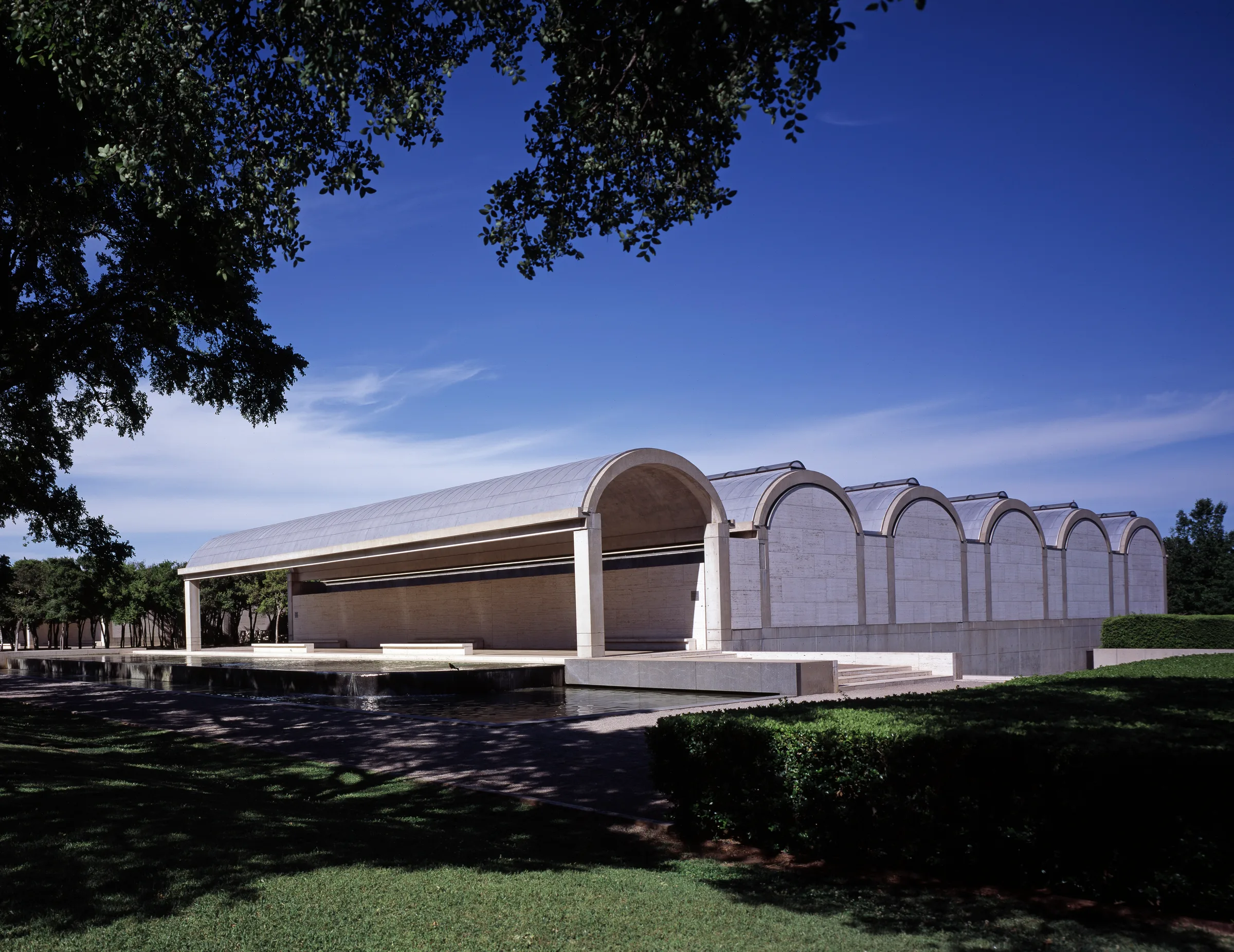 The low, repeated cycloid reinforced-concrete vaults and travertine façade of the Kimbell Art Museum