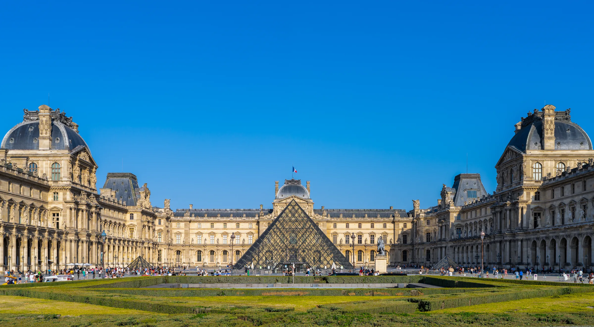The glass-and-steel pyramid in the Louvre courtyard, with the historic palace facade behind