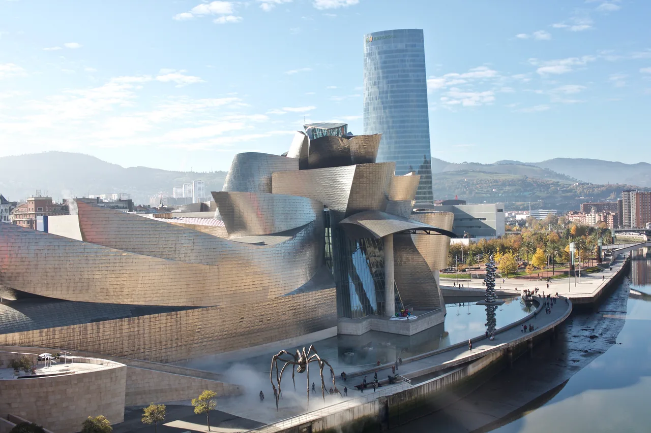 The titanium-clad, twisting curved forms of the Guggenheim Museum Bilbao