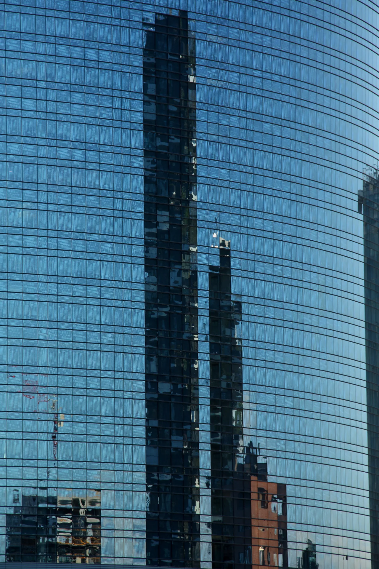 The balconied facades of the Bosco Verticale towers covered with trees and plants