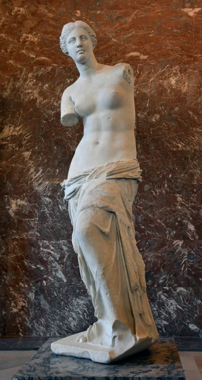 Front view of the Venus de Milo: a female figure with missing arms, bare upper body, lower body wrapped in marble drapery