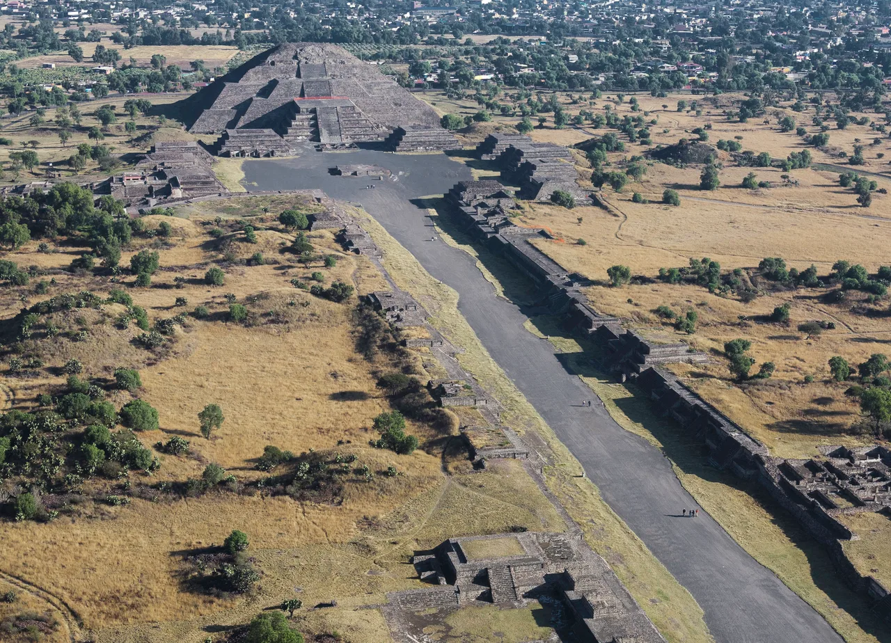 The Avenue of the Dead at Teotihuacan: a stepped platform in the foreground, the silhouette of the great Pyramid of the Sun behind