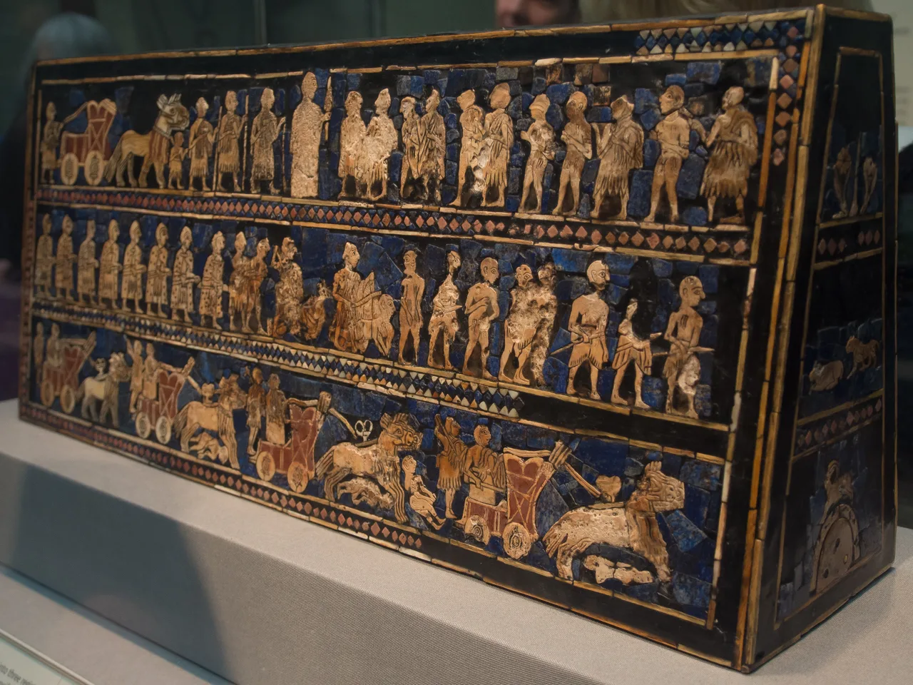 The 'Peace' side of the Standard of Ur: figures arrayed in three registers in shell, lapis lazuli, and limestone inlay
