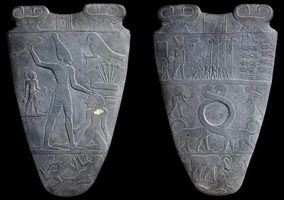Both faces of the Narmer Palette: a siltstone relief showing the king clubbing an enemy and inspecting decapitated foes