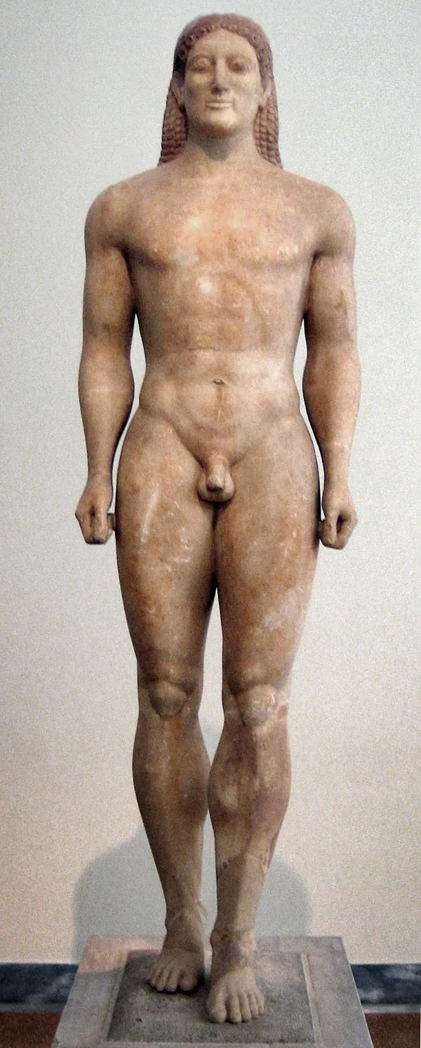The Kouros of Anavyssos: a marble statue of a naked young man standing with his left foot forward, lips curled in a faint smile