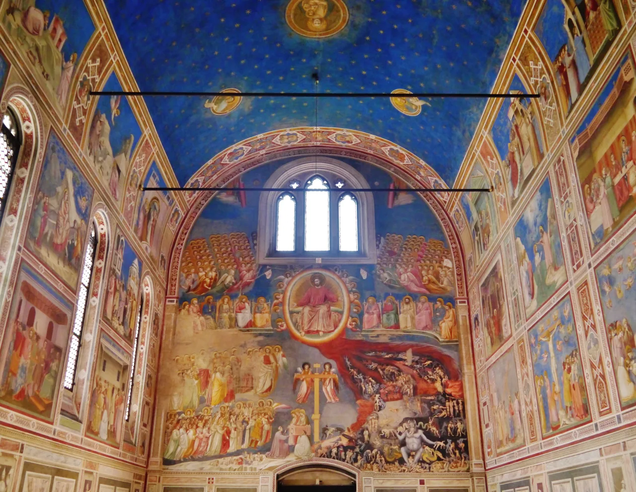 Interior view of the Scrovegni Chapel: starry blue vault, the Mary and Christ cycle on the side walls, and the Last Judgement on the west
