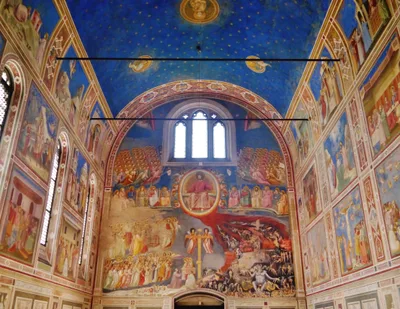 Interior view of the Scrovegni Chapel: starry blue vault, the Mary and Christ cycle on the side walls, and the Last Judgement on the west