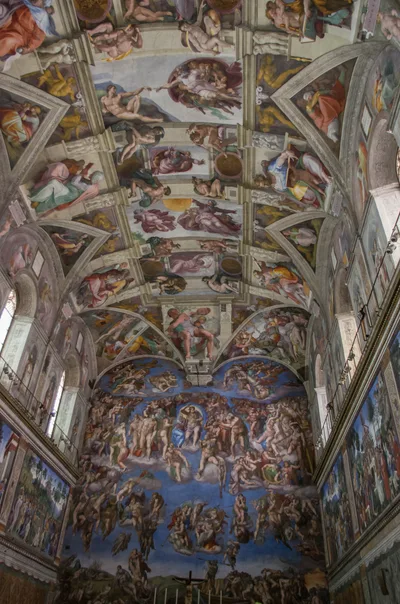 The frescoed Sistine Chapel ceiling: nine rectangular panels of Creation scenes set inside a painted architectural framework, surrounded by prophets and sibyls