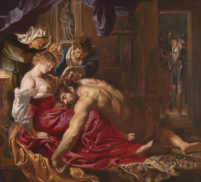 Rubens's Samson and Delilah: in candlelight, a servant cuts the hair of muscular Samson asleep in Delilah's lap, with soldiers waiting at the door
