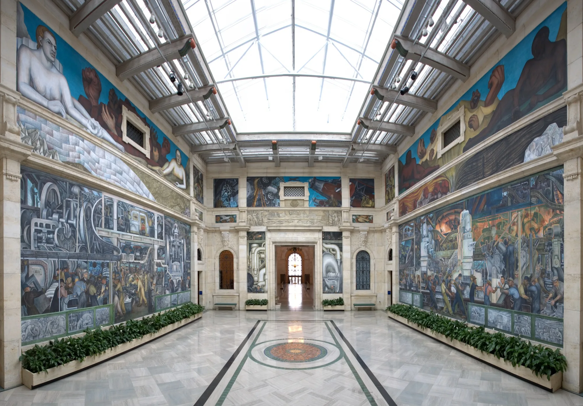 The west wall of the Detroit Industry murals: machinery, an assembly line and many worker figures