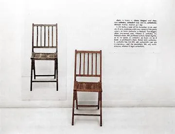 Kosuth's One and Three Chairs: on a white gallery wall, a large photograph of a chair on the left, the actual folding chair in the centre, and the dictionary definition of 'chair' on the right