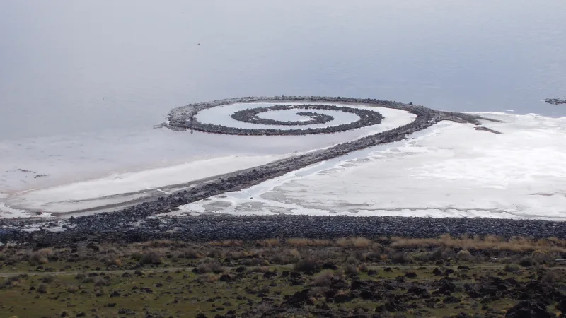 Spiral Jetty: a land art sculpture of stones and earth curling counterclockwise into the reddish waters of the Great Salt Lake
