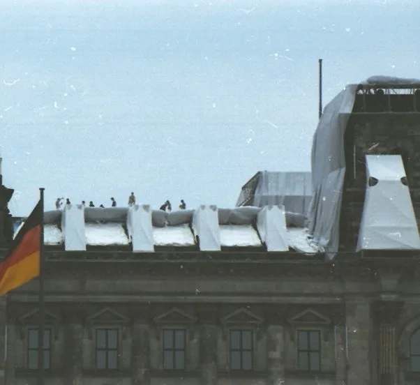 The Reichstag wrapped in silver fabric; the facade, columns, and dome have become rounded contours under the cloth