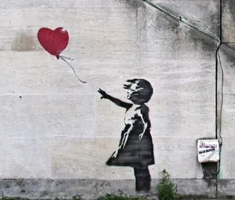 Banksy's Girl with Balloon stencil: a small girl reaching for a heart-shaped red balloon that drifts away above her hand