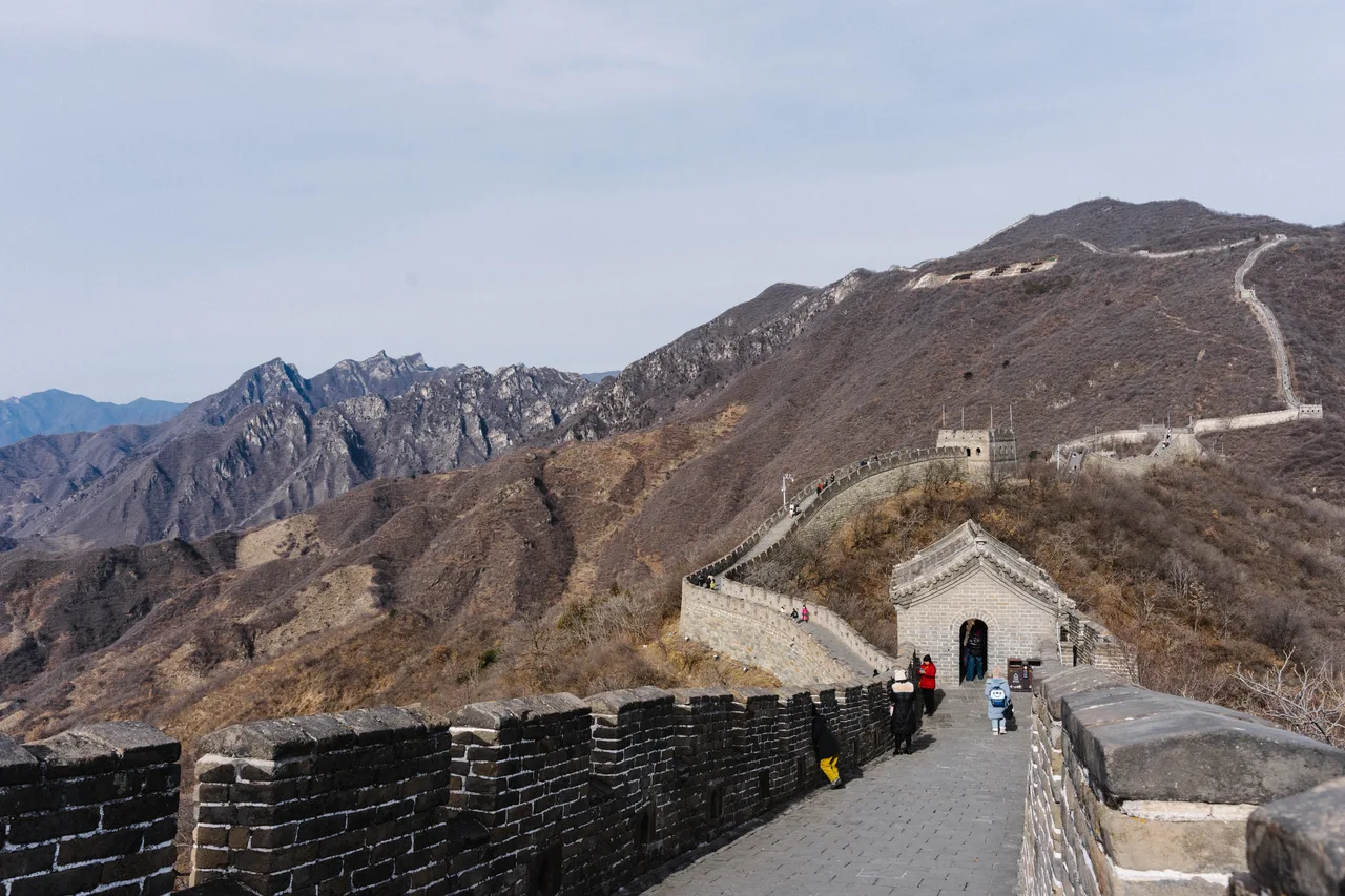 Aerial view of a long stretch of the Mutianyu section of the Great Wall winding along mountain ridges