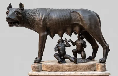 The Capitoline Wolf: a bronze she-wolf statue with two infant figures (Romulus and Remus) suckling beneath her