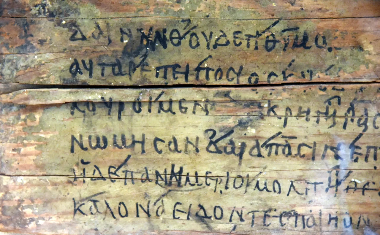 A wooden board inscribed in ink with lines 468–473 of Book I of the Iliad — Roman Egypt