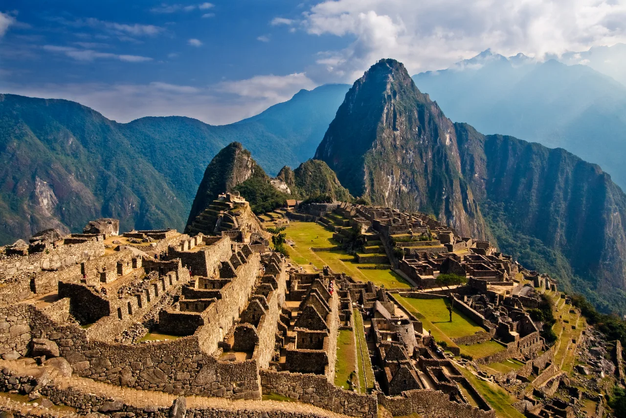 The classic view of Machu Picchu: the peak of Huayna Picchu in the background, terraces and stone ruins in the foreground