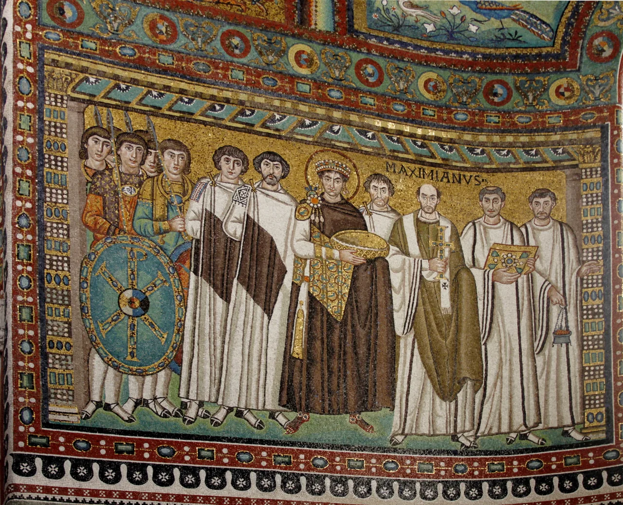 A sixth-century mosaic in the apse of San Vitale, Ravenna, showing Emperor Justinian I in the centre with a gold halo, surrounded by court officials, soldiers and clergy