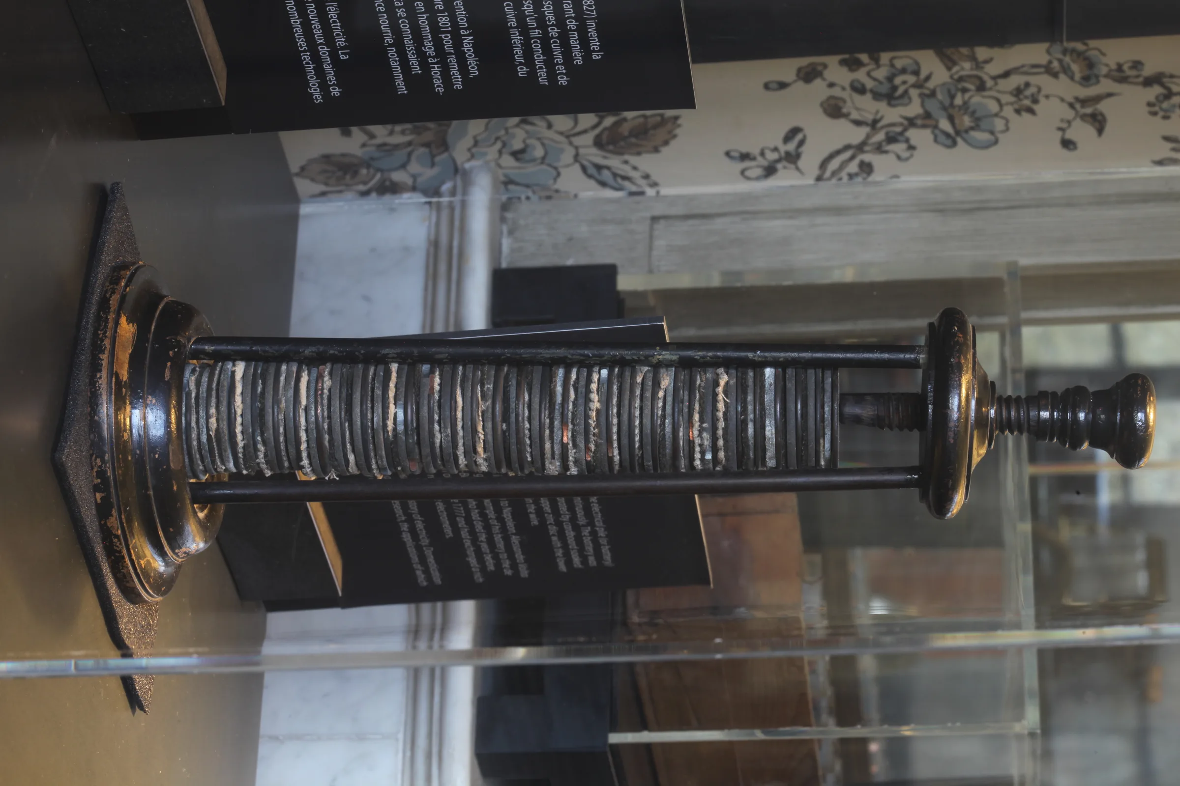 A period voltaic pile: metal discs stacked within a wooden frame