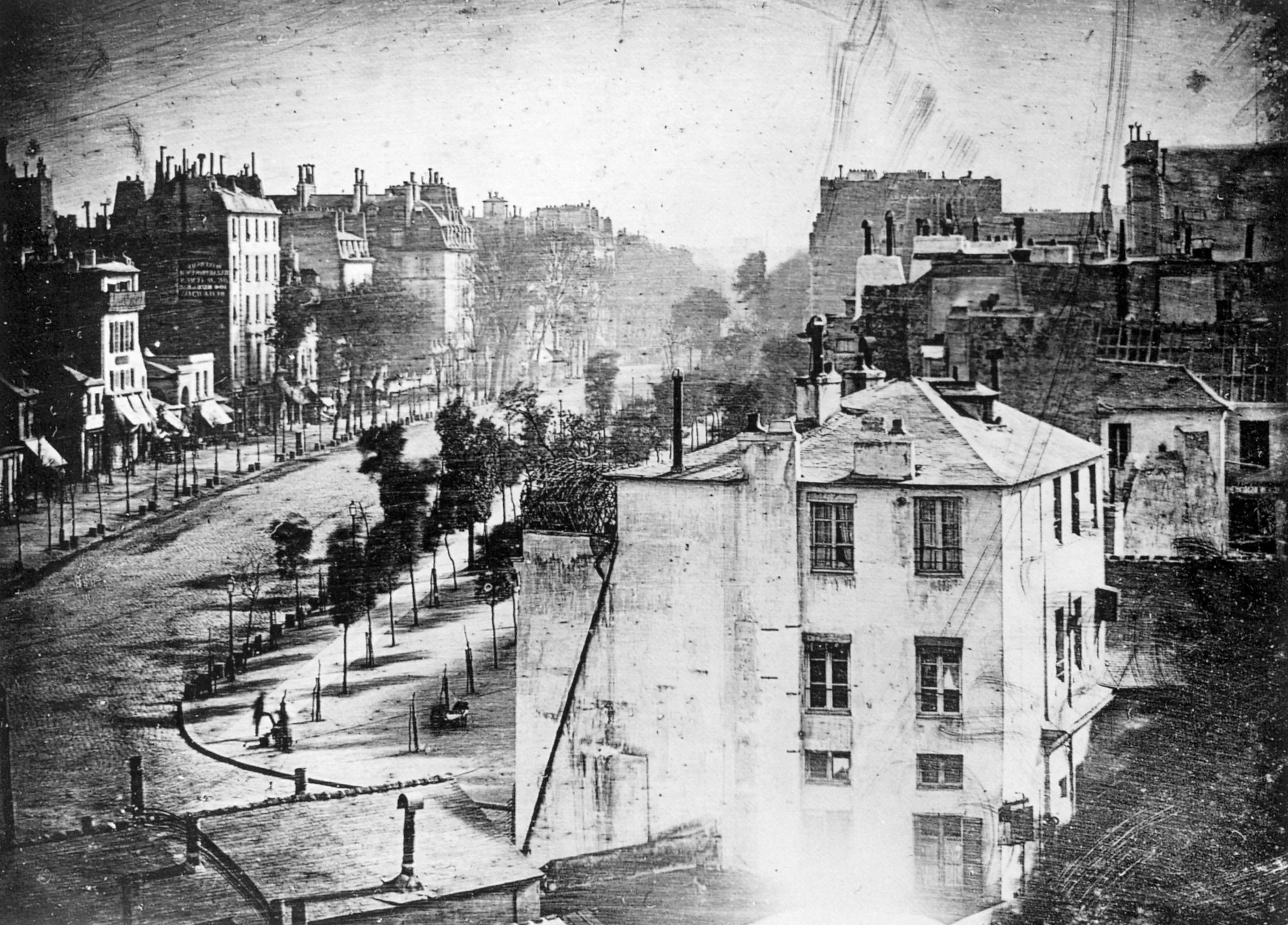 Daguerre's 1838 daguerreotype of the Boulevard du Temple in Paris; in the lower left a man having his boots polished is visible.