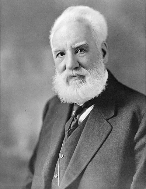 Studio portrait of Alexander Graham Bell: a bearded middle-aged inventor in a suit