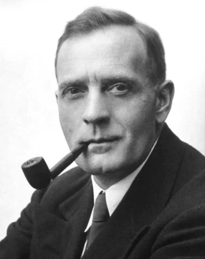 Studio portrait of Edwin Hubble: a thoughtful man with a pipe, in a suit