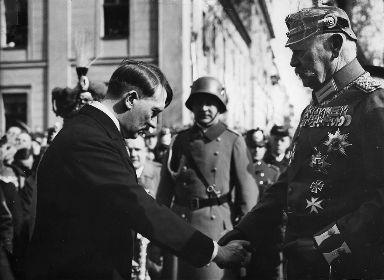 Potsdam Day, 21 March 1933: the new chancellor Adolf Hitler shakes hands with President Paul von Hindenburg in uniform