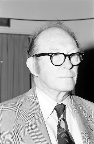 A 1974 photograph of Willard Libby: an elderly scientist in glasses and a suit